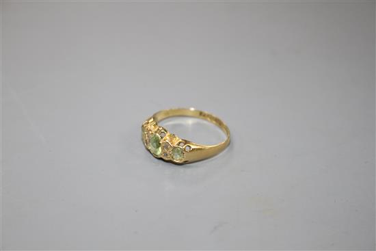 An early 20th century 18ct gold, green tourmaline and diamond chip set half hoop ring,